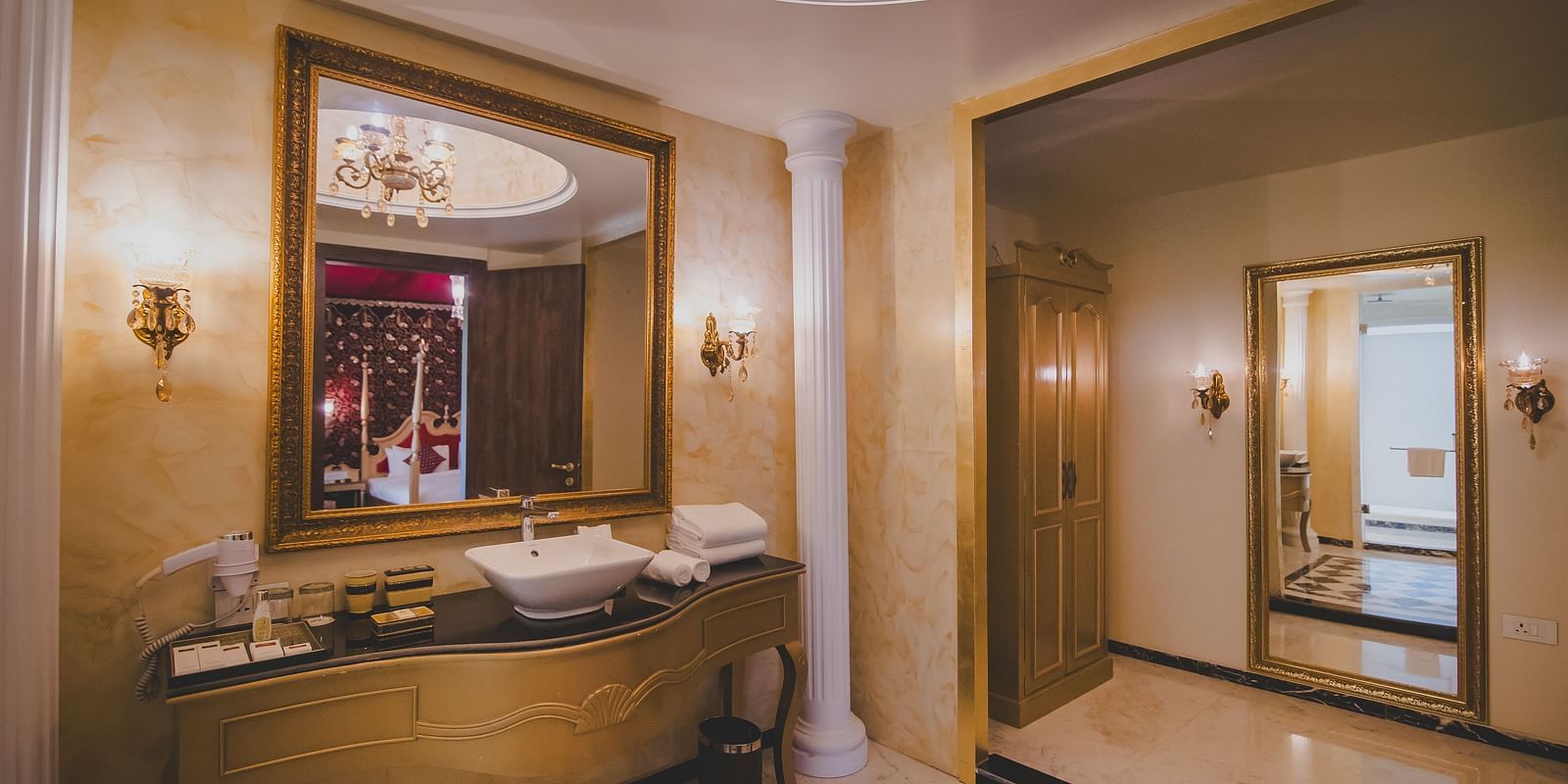 Image of a washroom with a sink and a large glass above it at Rajasthali Resort & Spa Jaipur.