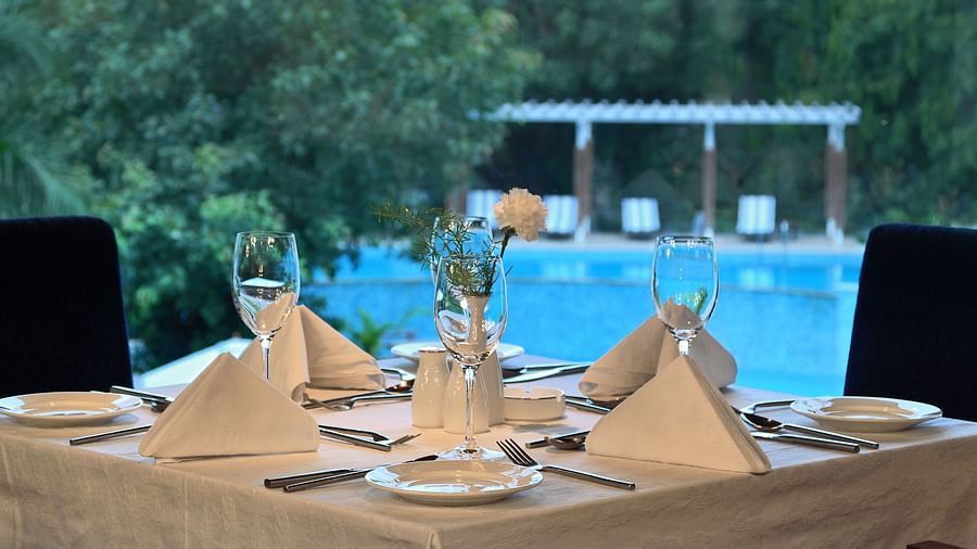 a dining table in front of the pool