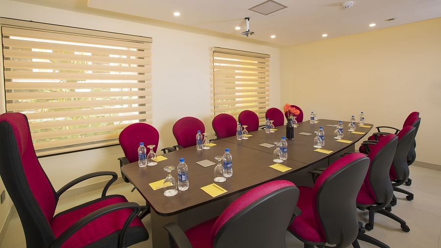 Chairs and table arranged in a boardroom setup, ready for the meeting