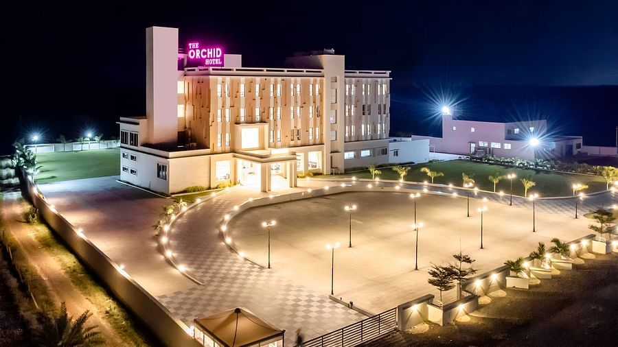 Facade image of The Orchid Hotel, Jamnagar in the night with the lights on 