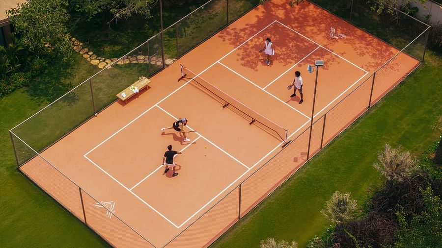 An aerial view of the pickle ball court at Villa Moira by V Escapes, with four people playing a match.