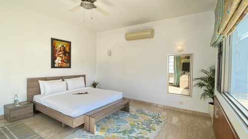 An overview of a bedroom inside Pranavam Villa - Karma Lakelands.