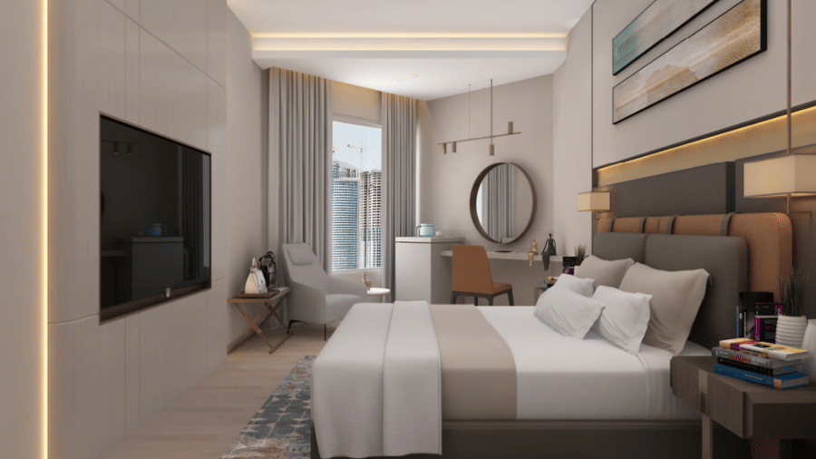 Executive room at Tulip Inn Bidar featuring a double bed, wall-mounted television, bedside tables, small seating area, desk, and round wall mirror.