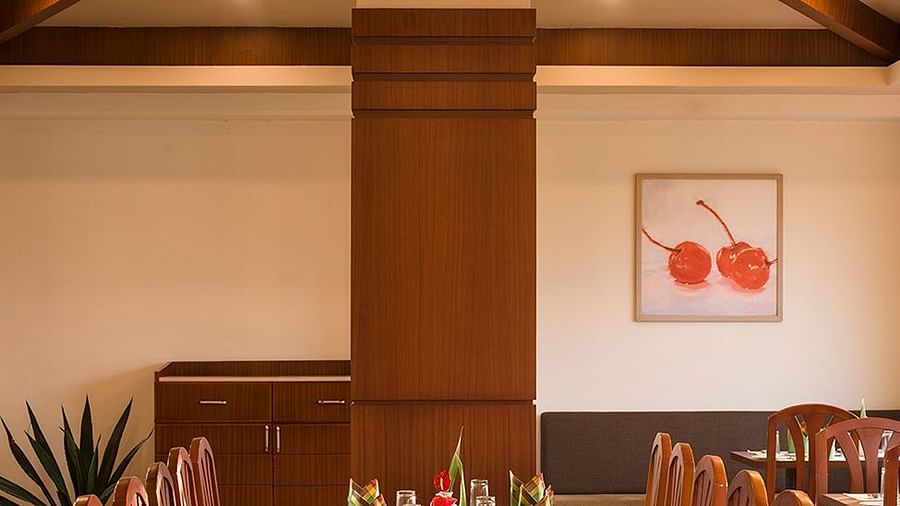 Restaurant interior with a focus on the wooden beams and pendant lighting - Abad Copper Castle, Munnar