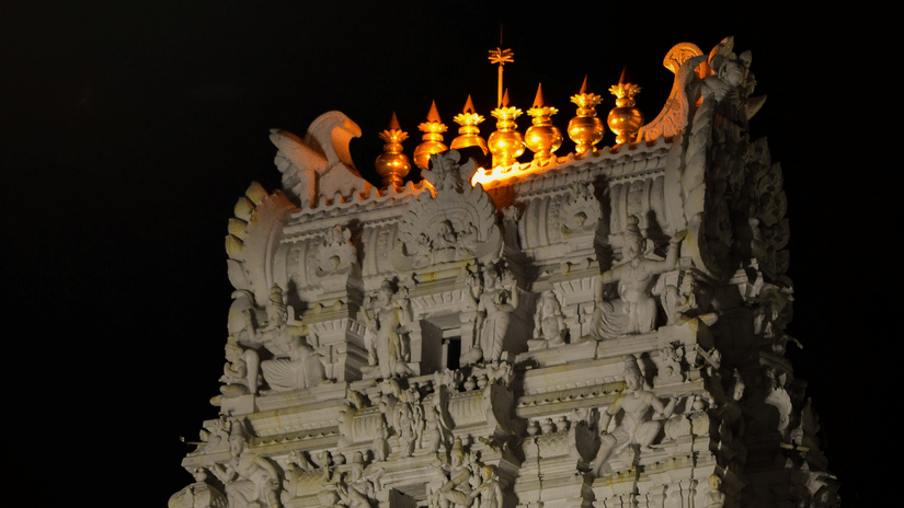 The vibrant building of Sri Govindaraja Swamy Temple in Tirupati, as seen during the night, with intricate art on the roof.