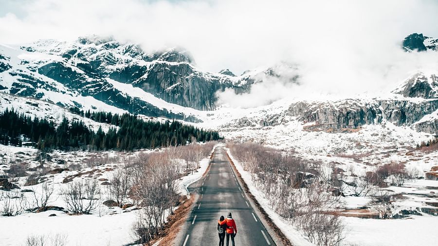 couple walking on a snow covered road 2