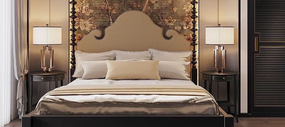 Front view of a well-made bed with cushions, a ceiling fan, and two bedside tables with lamps at The Evren, Vagator.