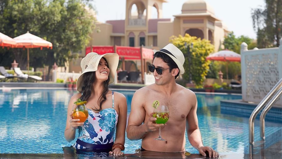 two people in front of a cool with beverages 