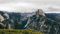 A wide angle view of the mountain peak with green grass