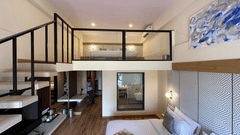 Kind size bedroom with a see through bathroom, a workstations, and stiars to the second deck at VITS Kamats Resort, Silvassa