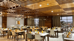 interior of a restaurant at VITS Satyajeet Karad featuring elegant seating arrangement