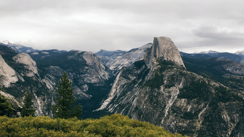 A wide angle view of the mountain peak with green grass
