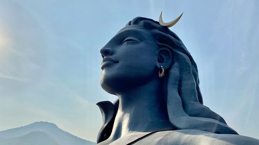 An overview of the statue of Adiyogi Shiva with a mountain in the background