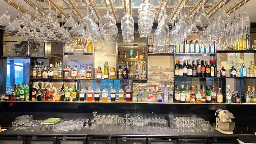 A bar counter with a showcase with drinks in them in the bar area at AKs Cocktail Bar - Karma Lakelands