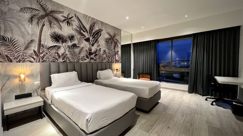 Picture featuring interior of room with a two cozy beds - The Hans Hotel Hubli