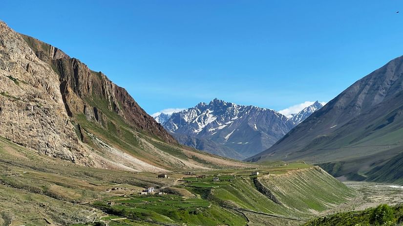 An overview of Pin Valley National Park with green valleys and snow capped mountains in view.