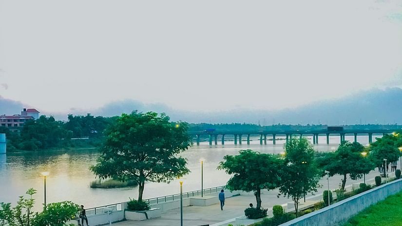 An overview of Silvassa Garden with a highway next to a waterbody in view