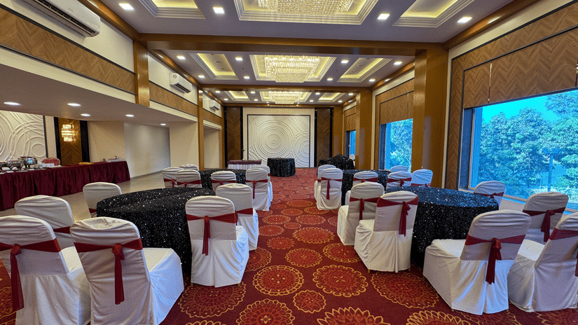 Full view of the Crystal Hall with a false ceiling and carpeted flooring at VITS Kamats Resort, Silvassa.
