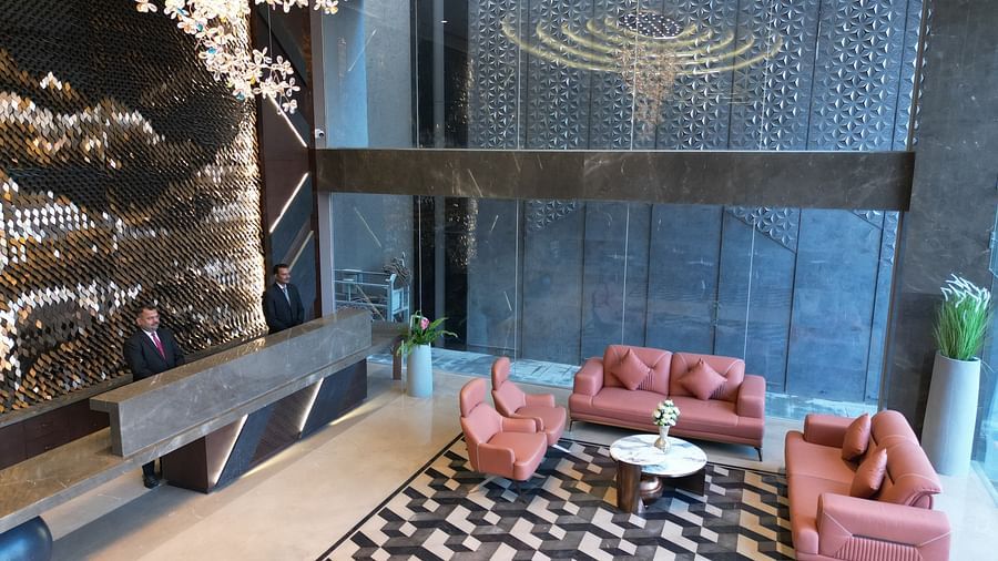 A lobby area with a front desk, plush sofa sets, and decorative elements in the background at Clarks Collection Grand Sapphire, Ajmer.