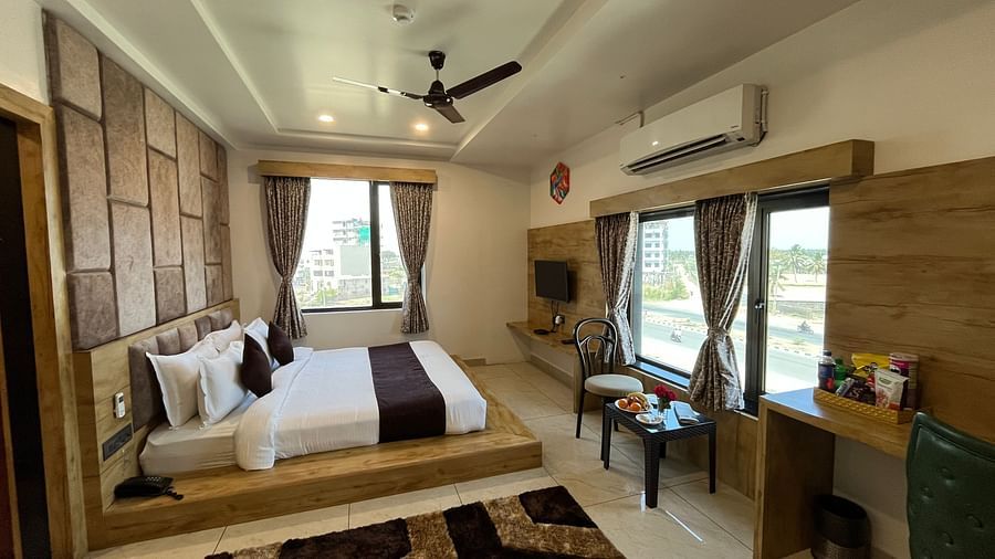 Side view of the premier room with a king-sized cosy bed at Clarks Collection, Somnath