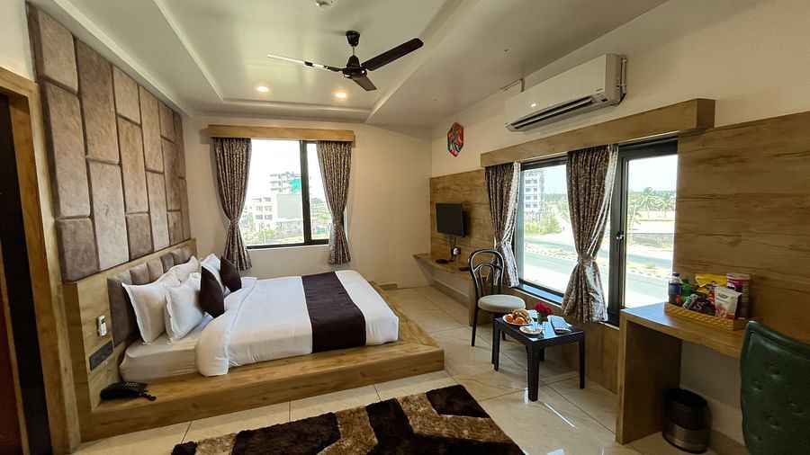 Side view of the premier room with a king-sized cosy bed at Clarks Collection, Somnath