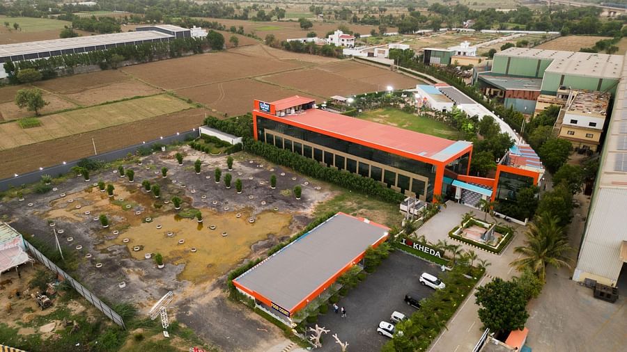Overhead aerial view of the Clarks Safari Kheda site, showing numerous buildings, connecting paths, vehicle areas, and planted sections