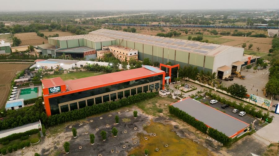 The view of Clarks Safari Kheda, revealing the hotel's elongated main building and its surrounding expansive environment with trees.