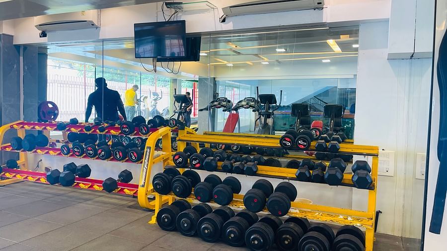 Dumbells racked up inside the gym room at Home2 Renaissance Club Hotel