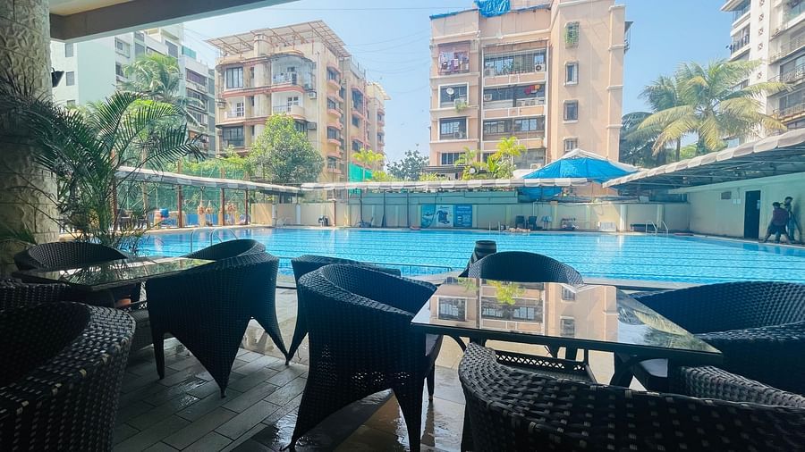 Seating arrangements opposite the swimming pool at Home2 Renaissance Club Hotel