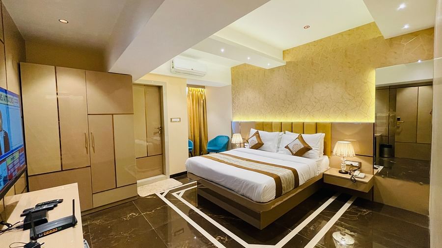 Side view of the king bed inside Deluxe Suite Room - Home2 Renaissance Club Hotel