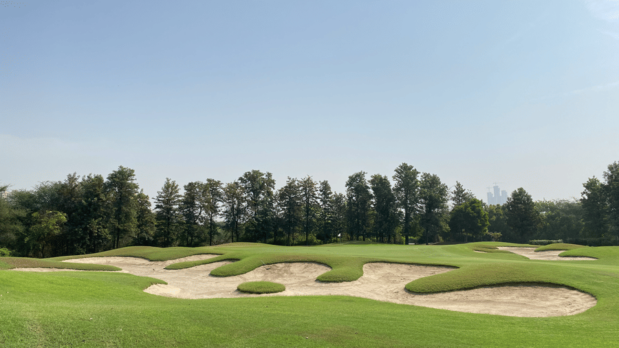 An overview of the golf course with trees and a sandpit in view at Karma Lakelands.