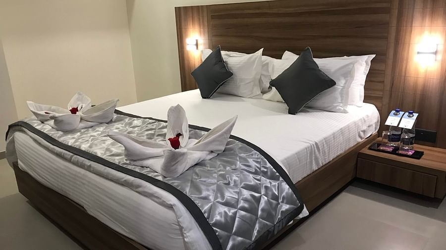 A shot of well-made bed in the Suite With Breakfast | Kyriad Hotel, Solapur