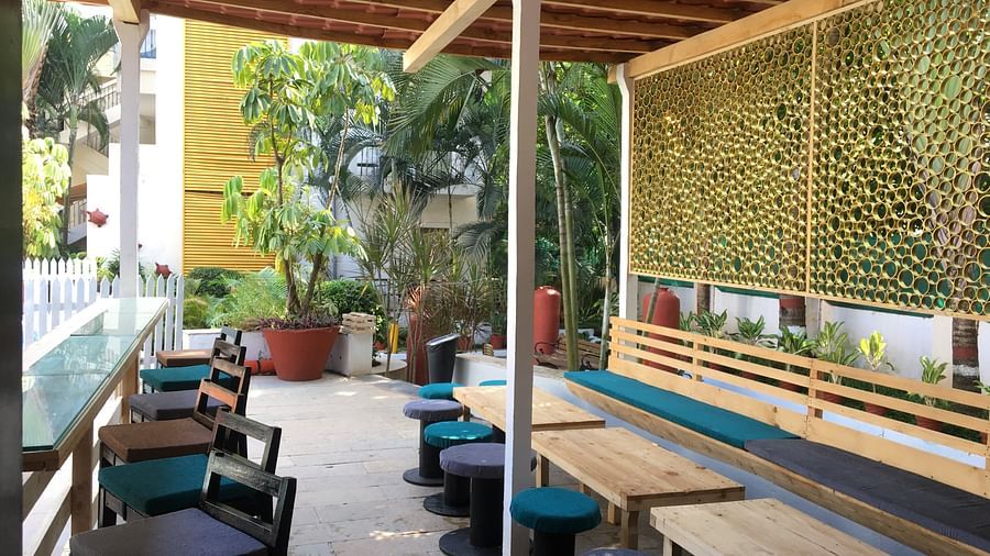 Tables and beautiful tiny bar stools at highground bar Kyriad Prestige Calangute, Goa