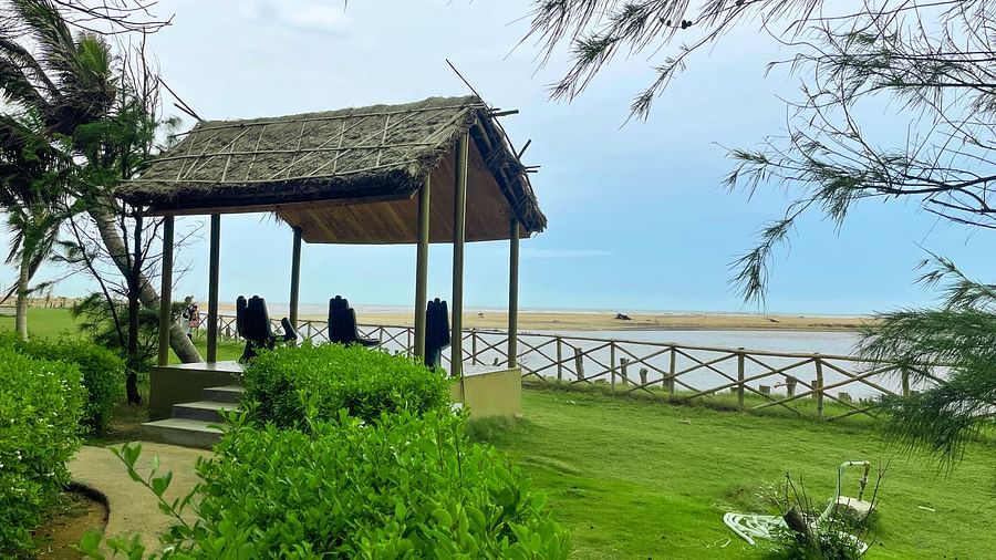  A bright and inviting dining area at Lotus Eco Beach Resort, with wooden tables set for a communal meal under a vaulted wooden ceiling, enhancing the dining experience with a touch of elegance.