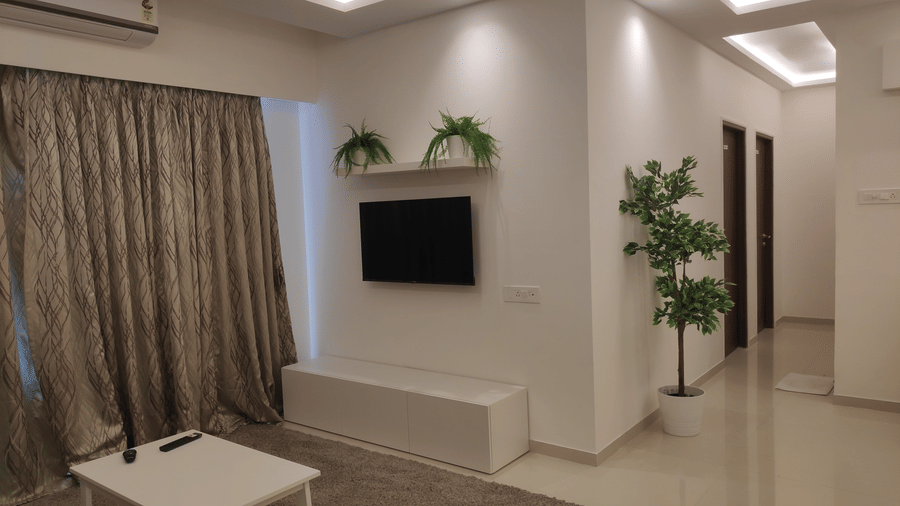 A picture of the hallway spruced up wit plants leading to the bedrooms in a 3 BHK service apartment in Andheri East