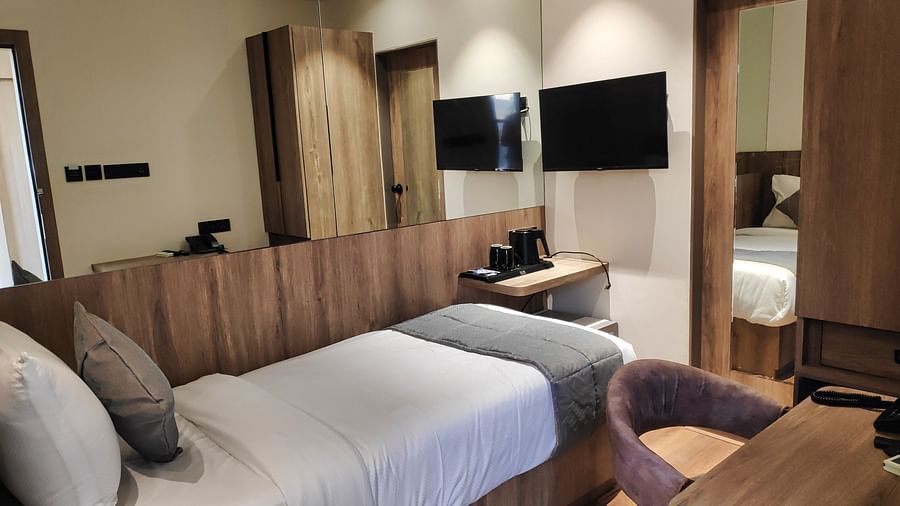 Hotel room with single bed and wooden interiors at Maxxvalue Hotel MIDC,  Mumbai