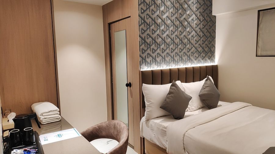 Double bed with table and chair at Maxxvalue Hotel MIDC,  Mumbai