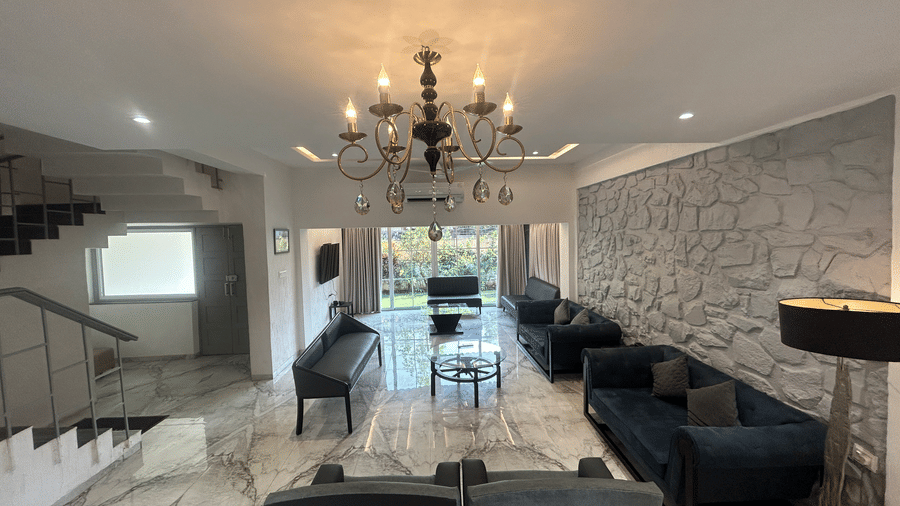 Lavish living room with a chandelier, marble flooring, and a sophisticated seating arrangement – Maxxvalue Klub Klass Villa, Lonavala.