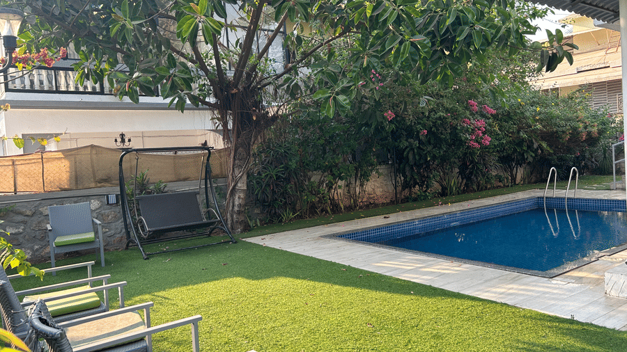 Serene private swimming pool, surrounded by lush greenery and comfortable lounge chairs – Maxxvalue Klub Klass Villa, Lonavala.