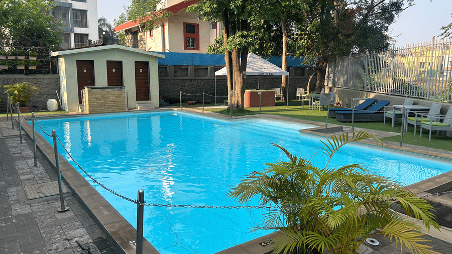 Sparkling outdoor swimming pool, surrounded by greenery and relaxing seating areas – Maxxvalue Klub Klass Villa, Lonavala.