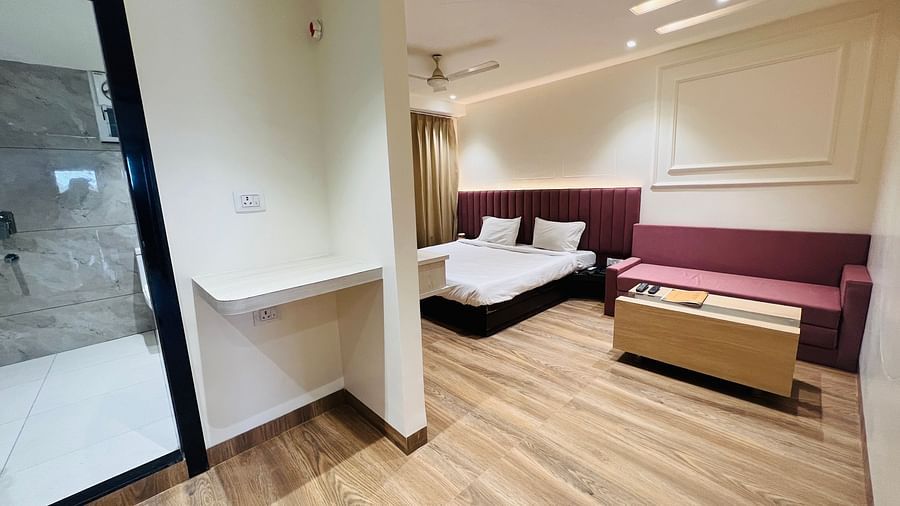 Premium Bedroom with a spacious bed, a sofa and a tea table- Hotel Morya, Bhopal