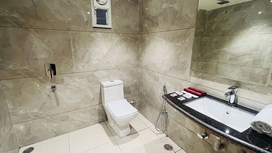 White floored bathroom with brown dispersed tiles -Hotel Morya, Bhopal