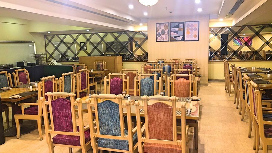 seating arrangments inside a restaurant with the lights switched on - Raj Park Hotel, Tirupati