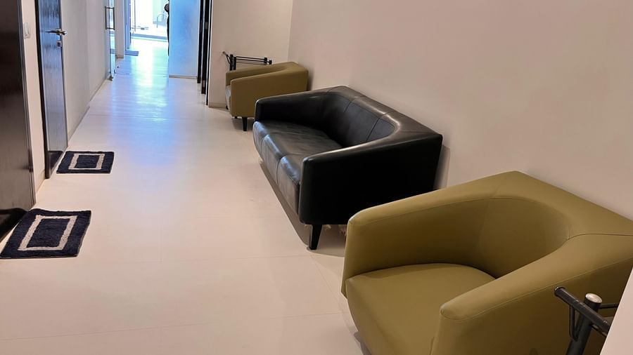 A bright lounge area with comfortable armchairs placed along the wall, offering guests a cosy seating space in a modern setting at Springs Hotel & Spa, Bangalore