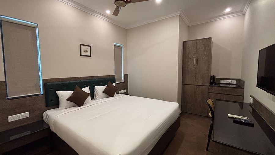 Club Room featuring a king size bed, a television, and a desk. - Still Waters, Varkala