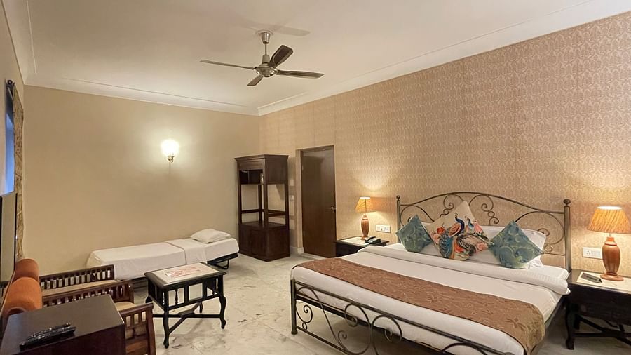 A double and a single bed in the Deluxe triple room at Suryaa Villa Jaipur