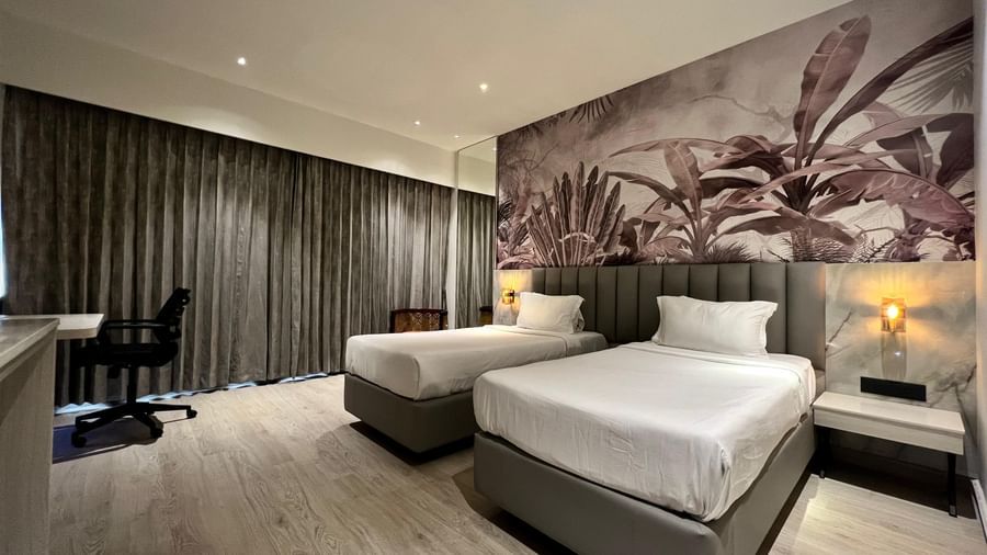 Picture featuring interior of room with a two cozy beds - The Hans Hotel Hubli