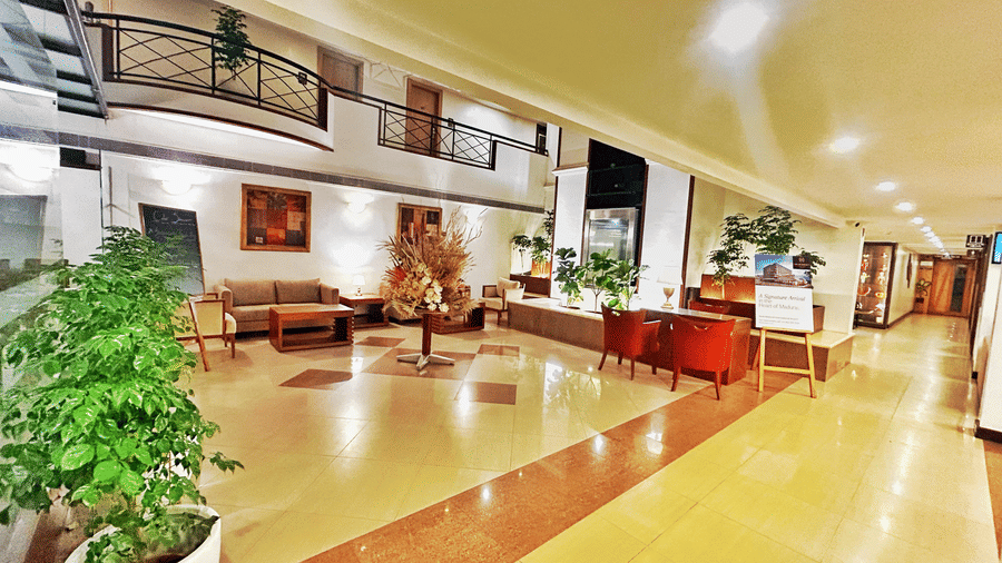 Spacious hotel lobby with elegant seating, warm lighting, and contemporary interiors.