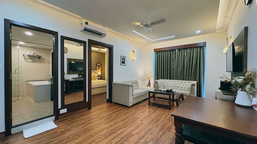 Suite with a selpreate living area, dining space at Vagator Downtown, Goa 