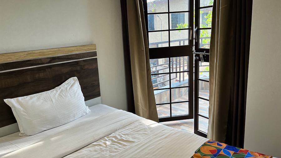 A close up shot of a bed near a window in our hotel room - VITS Select Kharadi, Pune